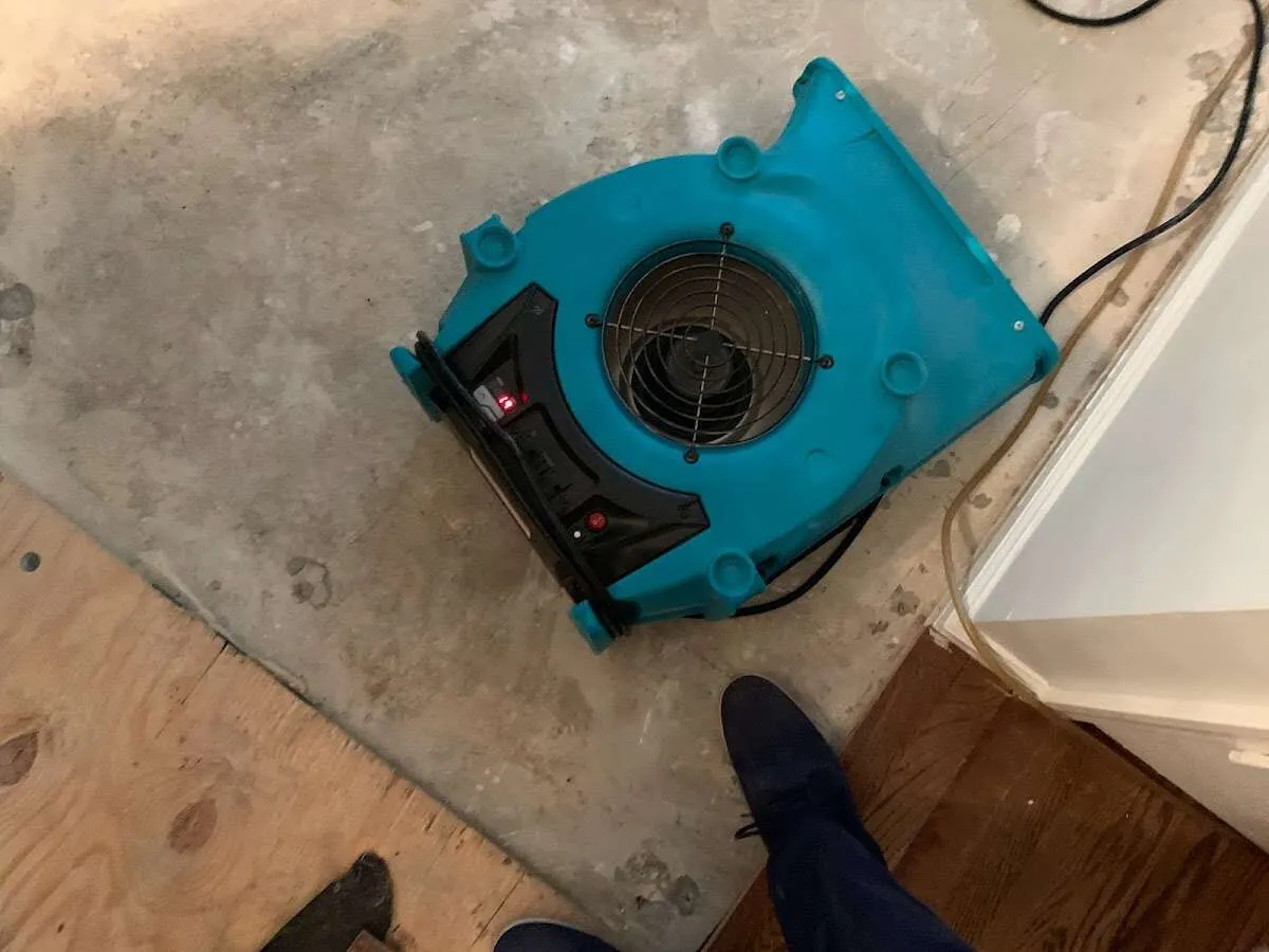 Air mover drying subfloor during Commercial Water Damage Restoration in Fort Payne